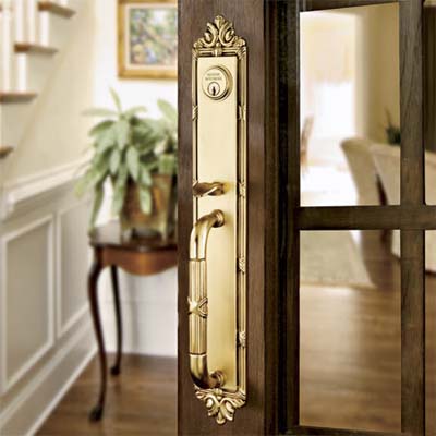forged brass entry set inset on wood and glass interior door