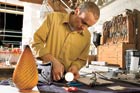 eric kaster making lighting fixture in workshop