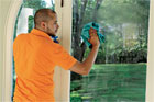 person cleaning a window
