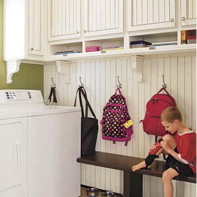 Child sitting in a remodeled mudroom 