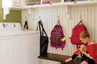Child sitting on bench in a budget redo mudroom
