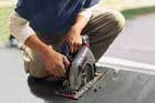 man using a circular saw to cut deck boards