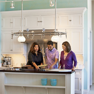Plans  Kitchen Island on Homeowners Going Over Plans With Kitchen Designer At Island