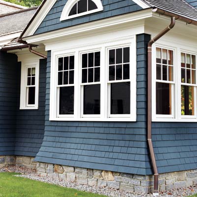 half-round copper gutters on a house with shingle siding