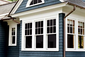 copper half-round gutters on a house with shingle siding