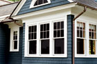 copper half-round gutters on a house with shingle siding