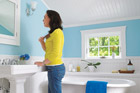 woman standing in remodeled cottage bath