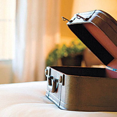 Open suitcase on the bed