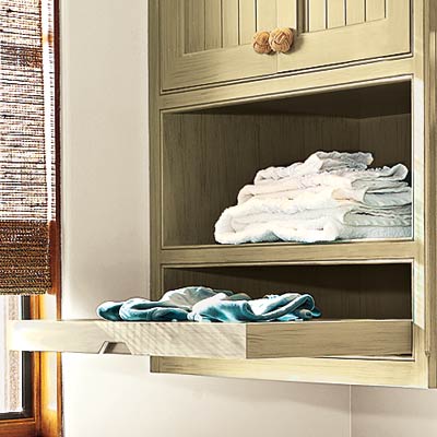 high efficiency laundry room with slide out drying racks