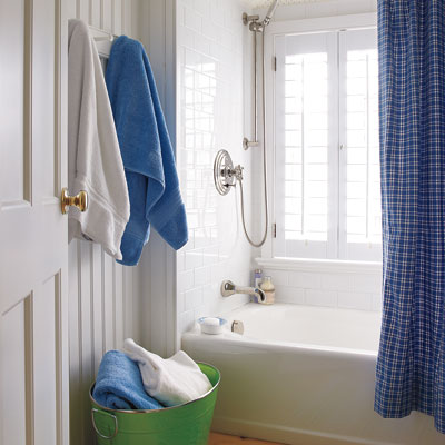 kids bathroom with beadboard walls and windowed tub