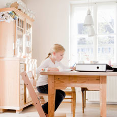 Girl doing homework at a desk table