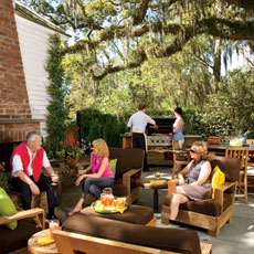 happy people sitting our beautifully designed outdoor kitchen