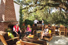 happy people sitting our beautifully designed outdoor kitchen