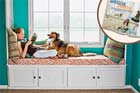 girl and dog sitting on window box seat built by reader based on story in this old house magazine