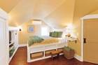 Yellow attic bedroom after remodel