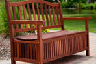 Wooden storage bench pictured on an outdoor patio
