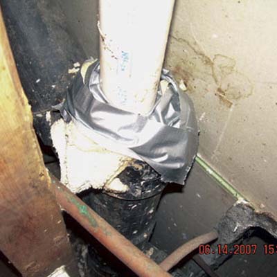 duct tape and cloth towel stuffed into a sewer pipe