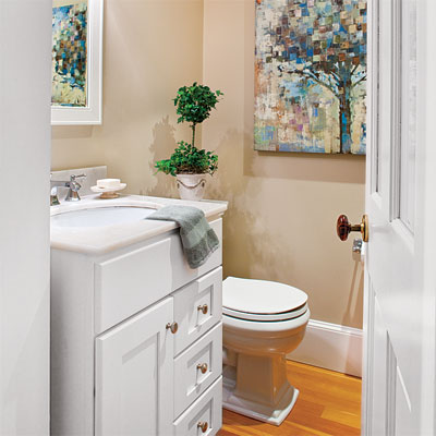 a small powder room was added to this home office upgrade with built-in bookshelves, powder room, and desk area