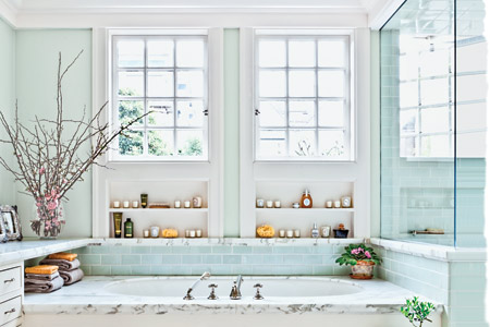 blue and white master bath with a marble-framed tub