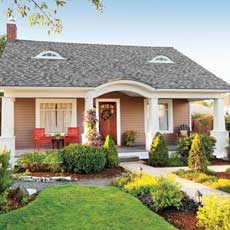 cottage exterior with plants and landscaping