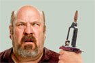 man holding up odd looking tool