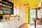 view of a kitchen in bright yellows and greens with a view to the door leading out to the patio