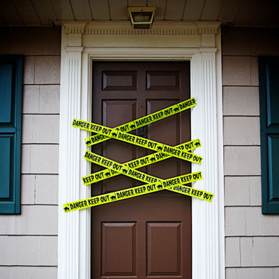 front door with yellow danger tape