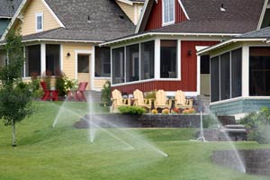 water sprinklers irrigating a landscaped residential area
