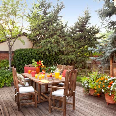 cedar dining deck with bristlecone pine, blue spruce and containers with marigolds, petunias, impatiens, vining mandevilla
