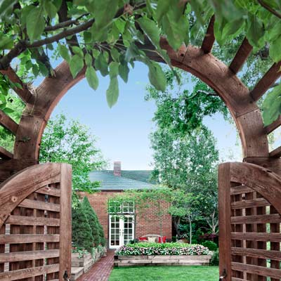 arched wisteria entry from back alley 