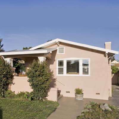 a stucco bungalow in the Temescal neighborhood, Oakland, California 
