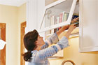 woman looking in cabinet