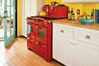 a kitchen filled with bright yellows and reds and greens