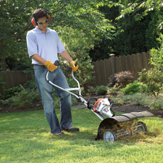 man working on a lawn with a Cultivator made by Stihl