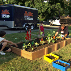 Roger Cook and kids around the completed raised vegetable garden