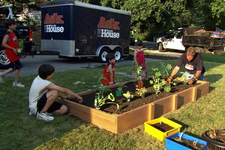 Roger Cook and kids around the completed raised vegetable garden