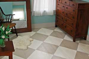 a bedroom painted in a beige and white diamond checker pattern