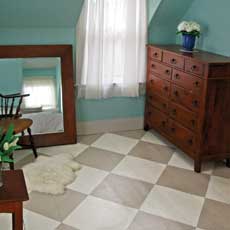 a bedroom painted in a beige and white diamond checker pattern