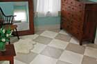 a bedroom painted in a beige and white diamond checker pattern