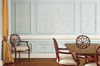 an interior wall patterned with hand-painted branches and leaves