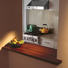 a sleek modern kitchen offset with the warm tones of a butcher-block countertop