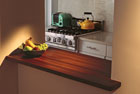 a sleek modern kitchen offset with the warm tones of a butcher-block countertop