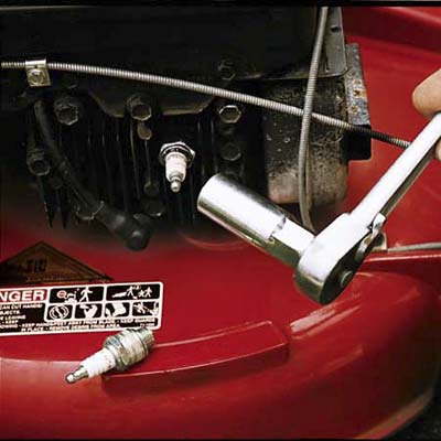Replace the mower's spark plug witha  socket wrench