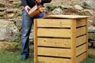 man pouring compost into his compost bin