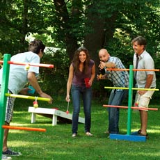men and women playing ladder golf yard game