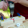 Drill a hole through each golf ball