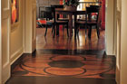 wood floor with painted framed medallion in hallway