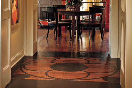 wood floor with painted framed medallion in hallway