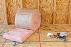 room with roll of insulation batting and tools