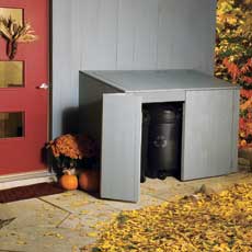 completed trash shed with door open showing 32-gallon recycling bin